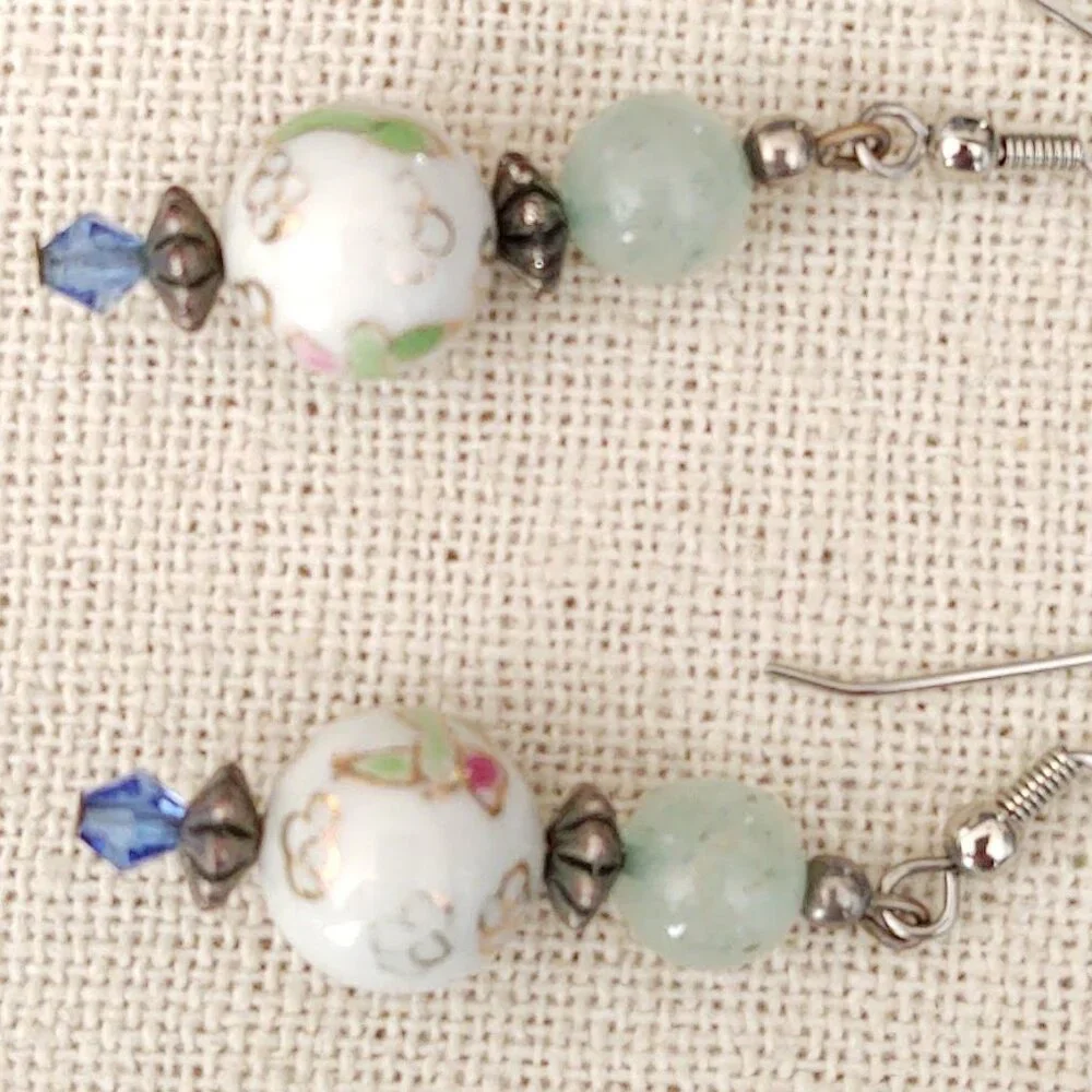 Floral painted ceramic beaded earrings with green and blue bead accents